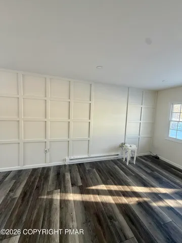 a view of a room with wooden floor
