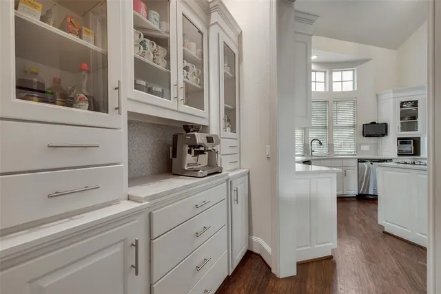 a kitchen with cabinets and window