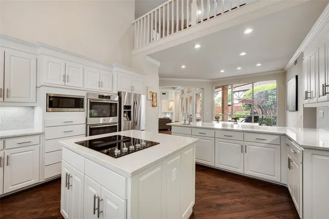 a kitchen with sink a stove and cabinets