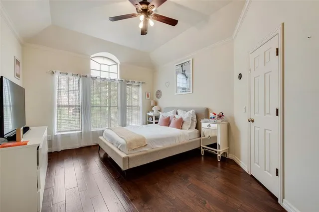a bedroom with a large bed and a chandelier