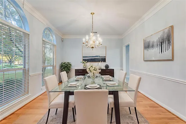 an empty room with windows and ceiling fan
