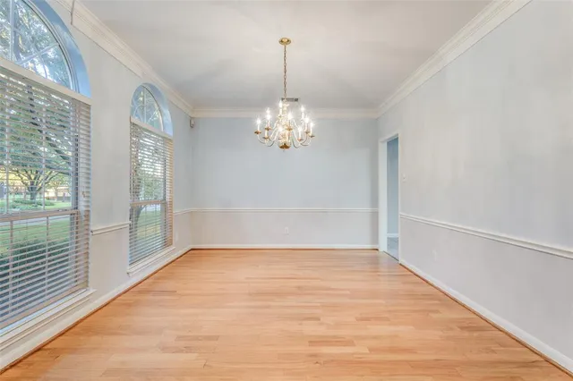 an empty room with a ceiling fan and window