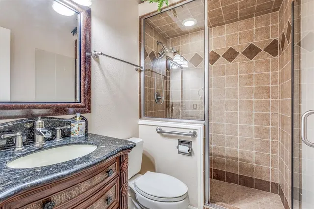 a bathroom with a sink double vanity granite tub and a mirror