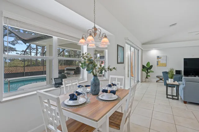 a kitchen with a faucet a potted plant on the counter and a glass door
