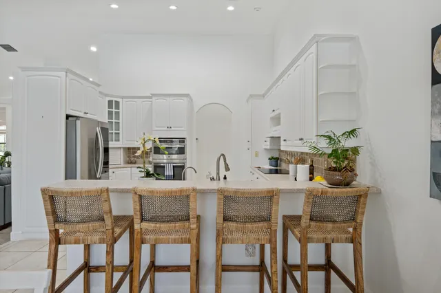 a view of a dining room with furniture a chandelier and wooden floor
