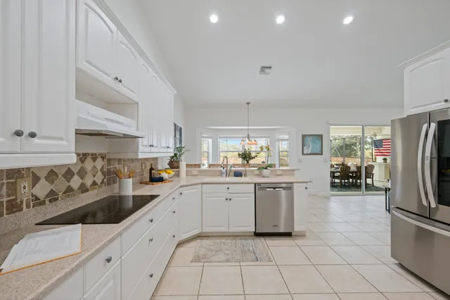 a spacious bedroom with a bed and a flat screen tv