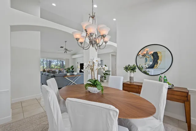 a view of a dining room with furniture large windows and wooden floor