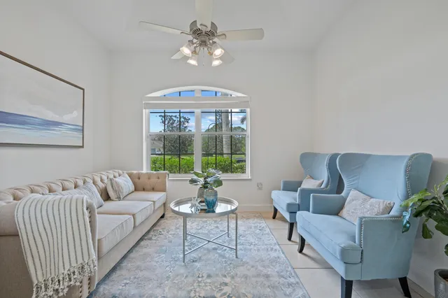 a view of a patio with couches chairs and a wooden floor