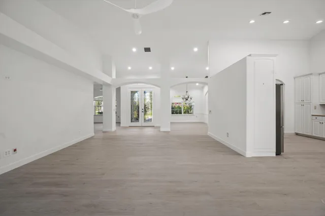 a view of a kitchen with white and a refrigerator