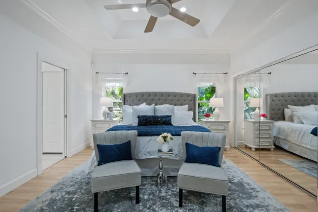 an aerial view of residential houses with outdoor space and trees