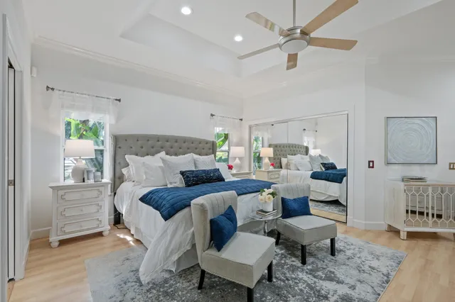 a view of a fountain in a yard with palm trees
