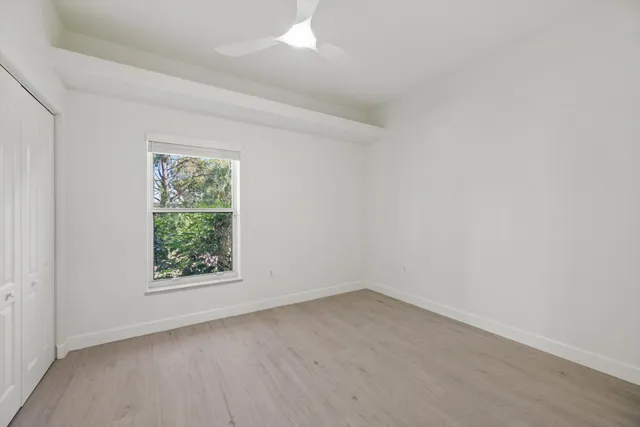 a front view of a house with garden and trees