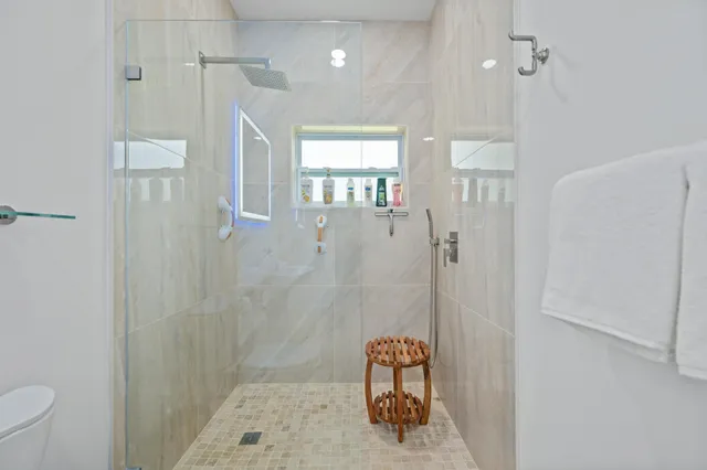 a view of an ocean with boats and trees in the background