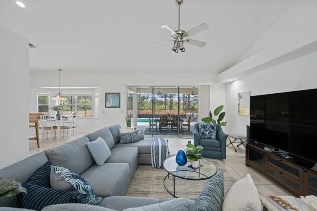 a dining room with furniture a chandelier and window