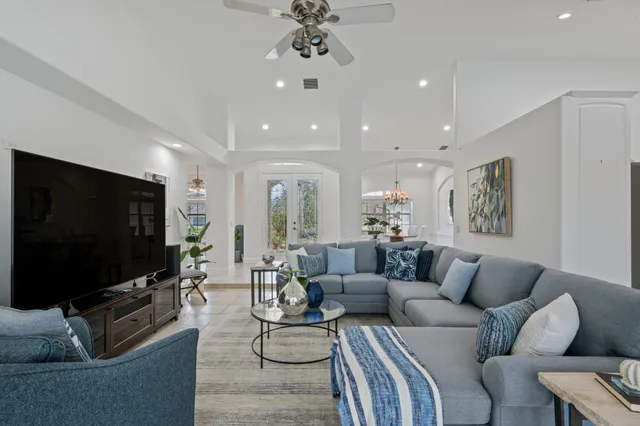a kitchen with stainless steel appliances a stove a sink and white cabinets