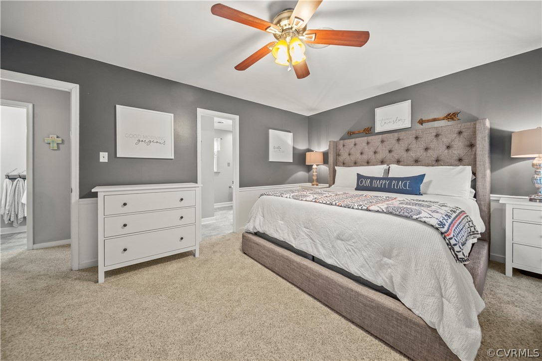 10806 Ridgerun Road Chesterfield, VA 23832 - Photo 27 of 48 a bedroom with a bed and a chandelier