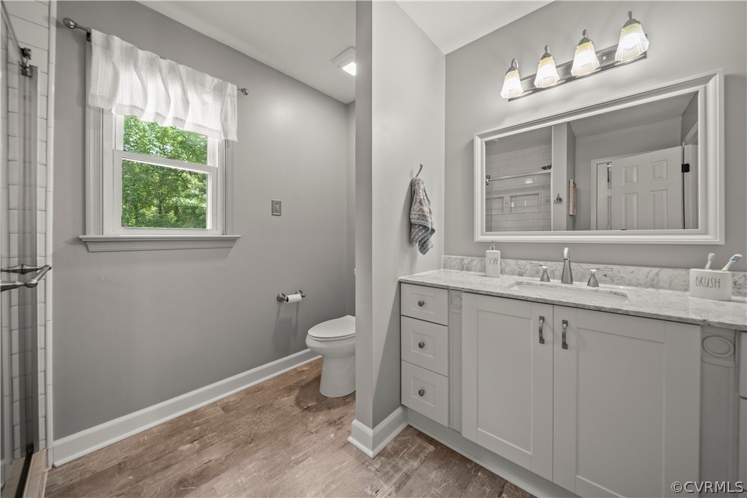 10806 Ridgerun Road Chesterfield, VA 23832 - Photo 28 of 48 a bathroom with a granite countertop sink a toilet and a window