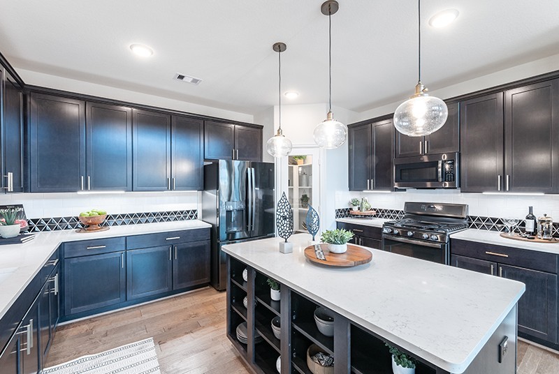 7810 Bear Trace Road Fairview, TN 37062 - Photo 5 of 20 a kitchen with a stove a kitchen island a sink cabinets and stainless steel appliances