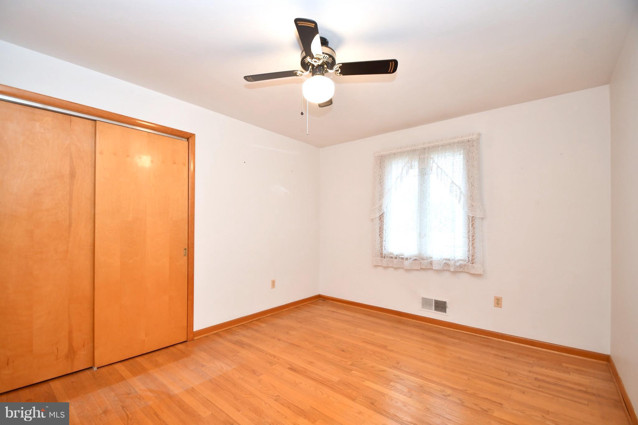 9412 Dawnvale Road Baltimore, MD 21236 - Photo 17 of 28 a view of empty room with window and ceiling fan