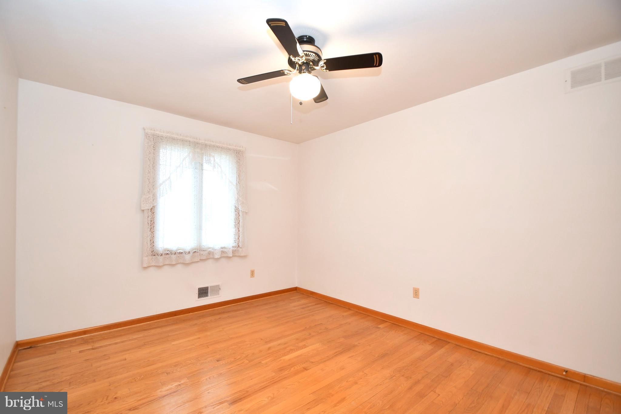 9412 Dawnvale Road Baltimore, MD 21236 - Photo 18 of 28 a view of empty room with wooden floor