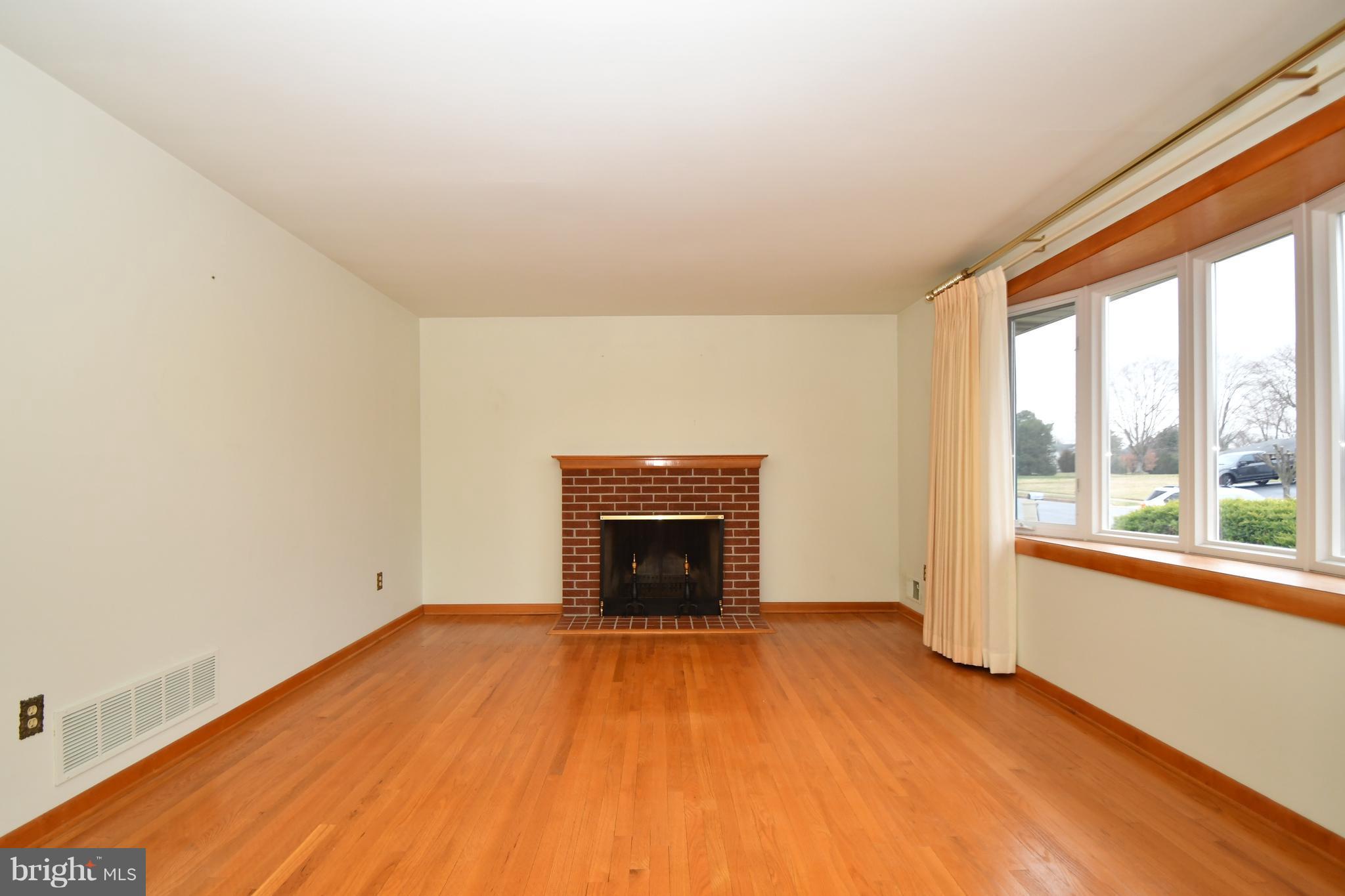 9412 Dawnvale Road Baltimore, MD 21236 - Photo 3 of 28 an empty room with windows and fireplace