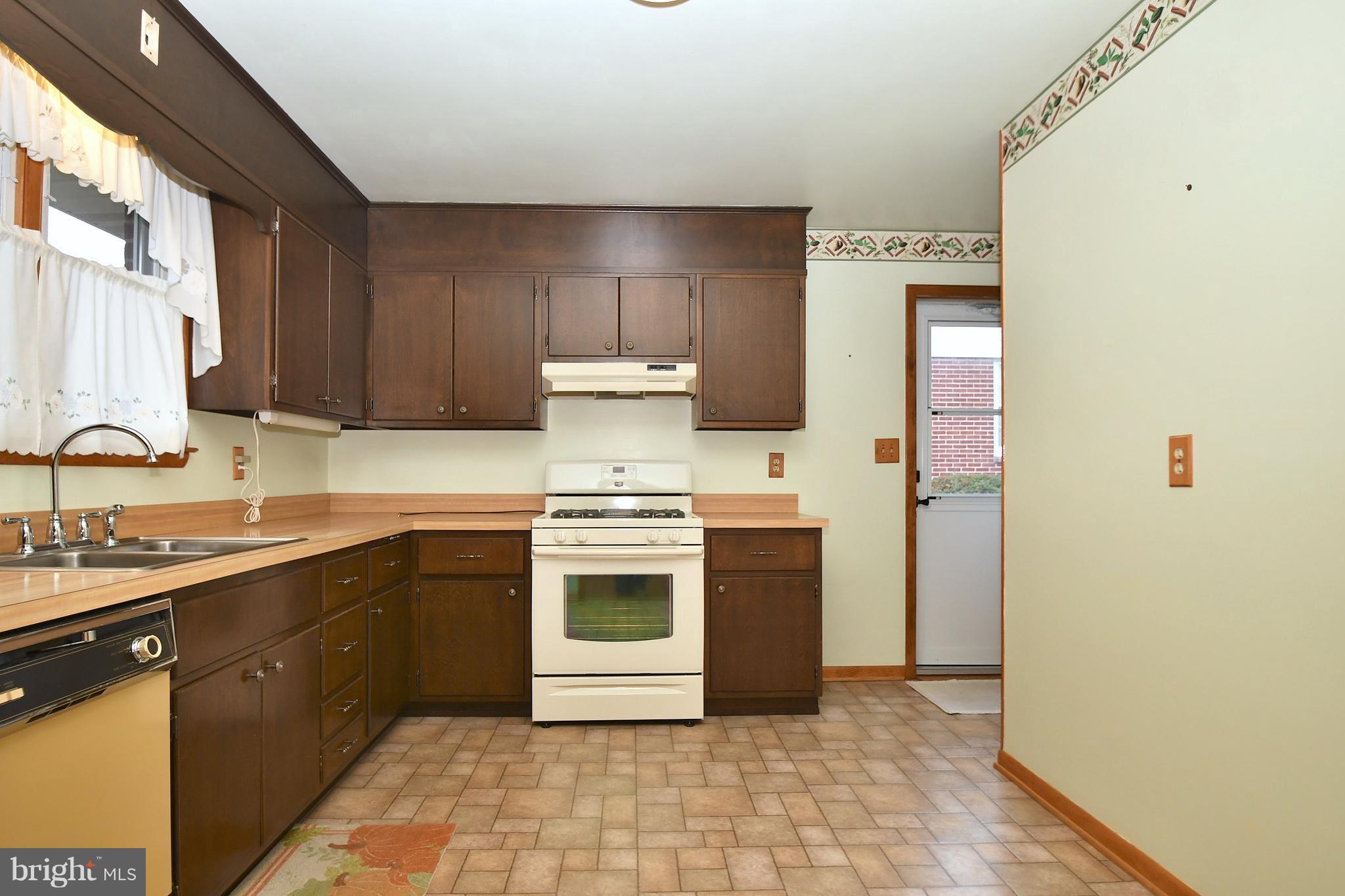 9412 Dawnvale Road Baltimore, MD 21236 - Photo 10 of 28 a kitchen with a sink stove and cabinets