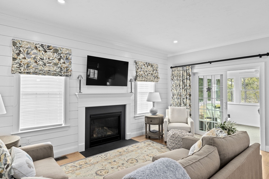 31 Farm Road Plymouth, MA 02360 - Photo 12 of 37 a living room with furniture a flat screen tv and a fireplace