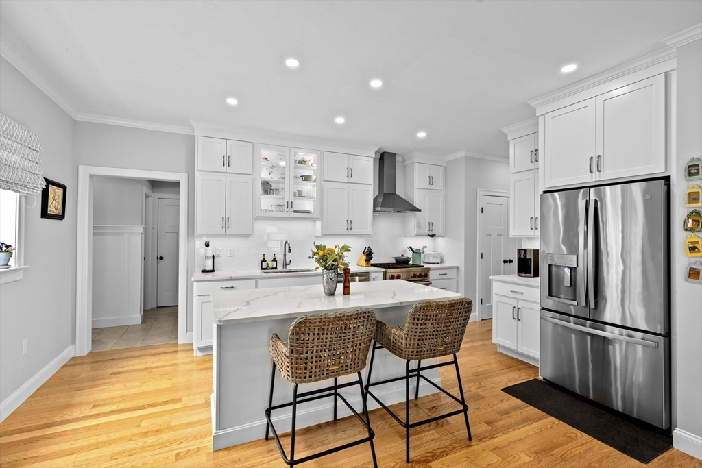 31 Farm Road Plymouth, MA 02360 - Photo 4 of 37 a kitchen with stainless steel appliances a refrigerator a stove a sink and white cabinets with wooden floor
