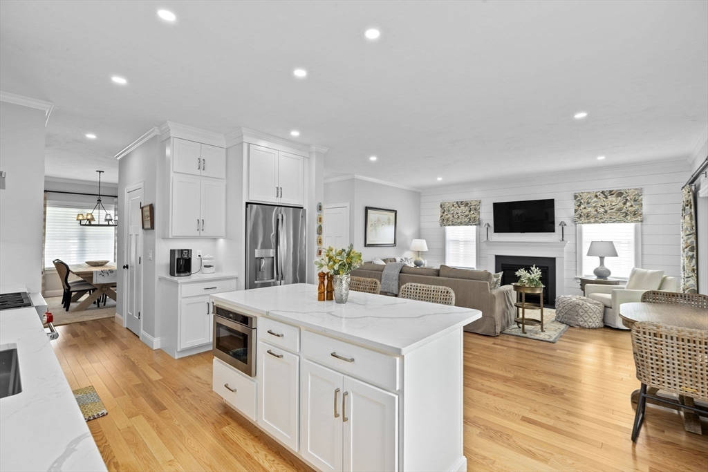 31 Farm Road Plymouth, MA 02360 - Photo 9 of 37 a kitchen with stainless steel appliances kitchen island granite countertop a refrigerator oven a sink dishwasher and white cabinets with wooden floor