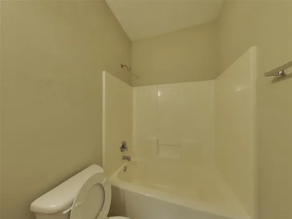 a bathroom with a toilet and a bathtub