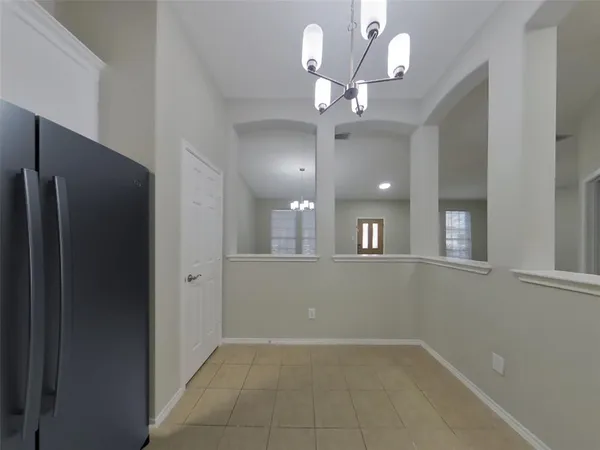 a view of an empty room with a kitchen