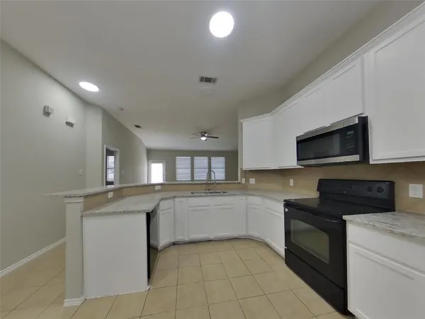 a kitchen with stainless steel appliances granite countertop a sink and a stove