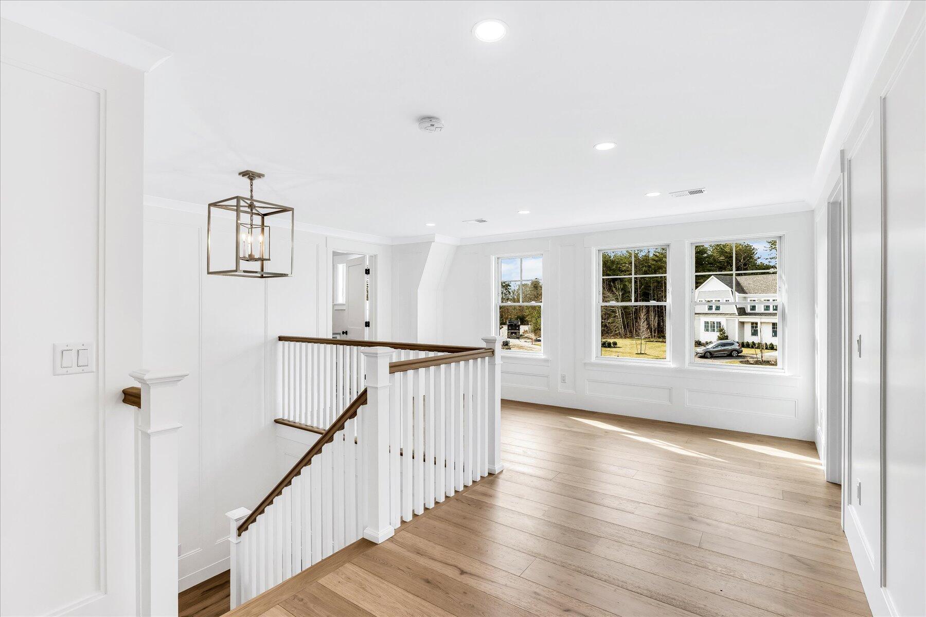 19 Willow Circle Mashpee, MA 02649 - Photo 24 of 42 a view of a hallway with wooden floor and windows