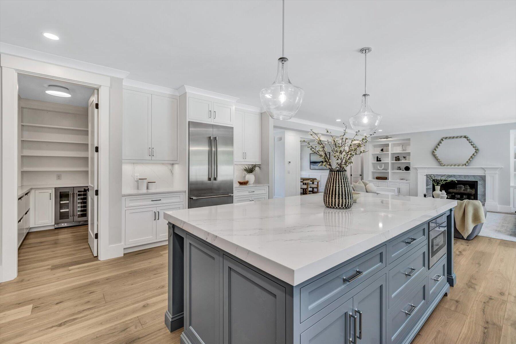 19 Willow Circle Mashpee, MA 02649 - Photo 7 of 42 a large kitchen with kitchen island white cabinets and wooden floor