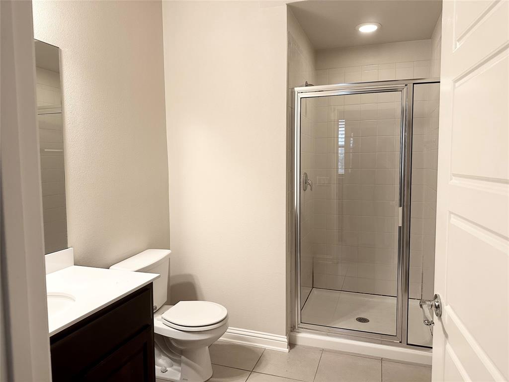 6814 East Riverside Drive, Unit 26 Austin, TX 78741 - Photo 17 of 21 A well-appointed bathroom features a spacious walk-in shower and a modern vanity.
