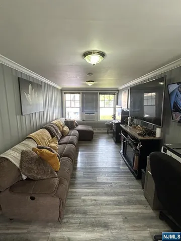 a living room with furniture window and wooden floor