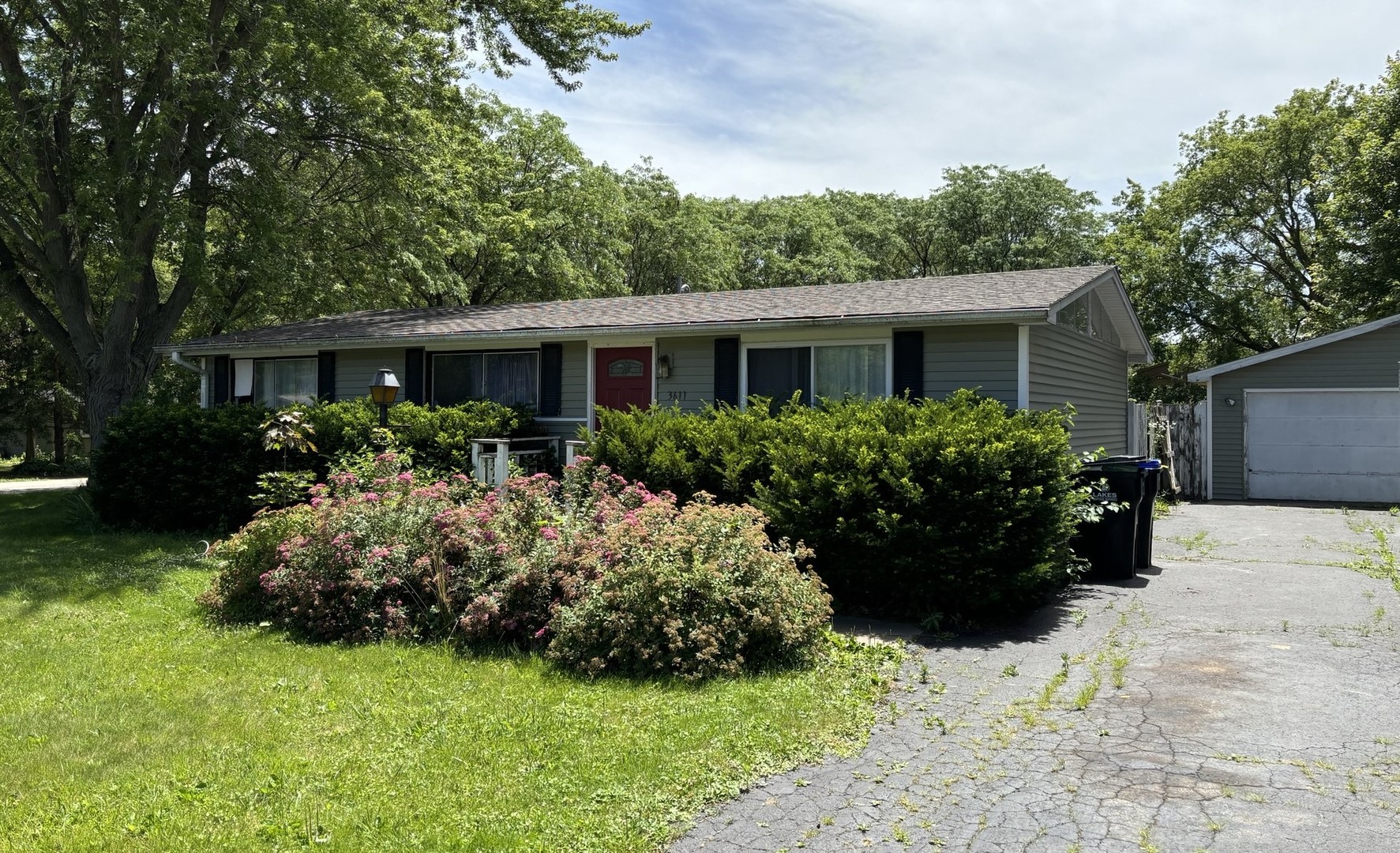 a front view of house with yard and green space
