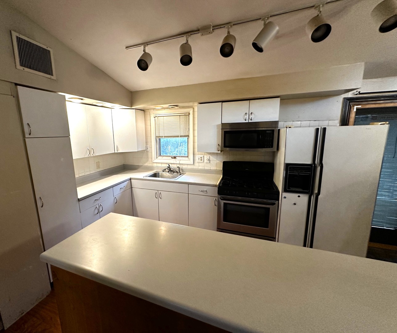 3611 Fillmore Road Johnsburg, IL 60051 - Photo 5 of 10 a kitchen with stainless steel appliances a refrigerator sink and microwave