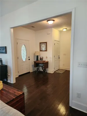 a view of a livingroom with wooden floor and a cabinet