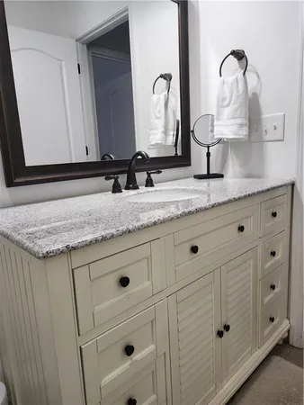 a bathroom with double sink and a mirror