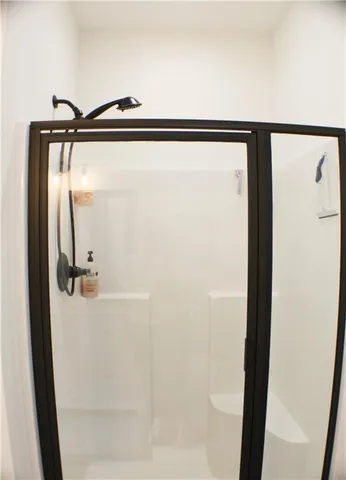 a bathroom with a shower and a mirror