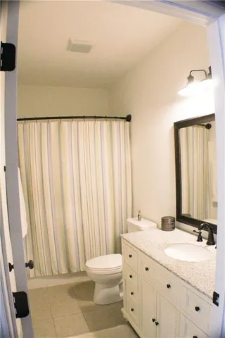 a bathroom with a double vanity sink mirror and toilet