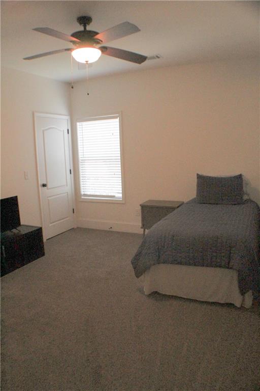 1175 Diamond Hill Colbert Road Colbert, GA 30628 - Photo 25 of 27 a spacious bedroom with a bed and a chandelier