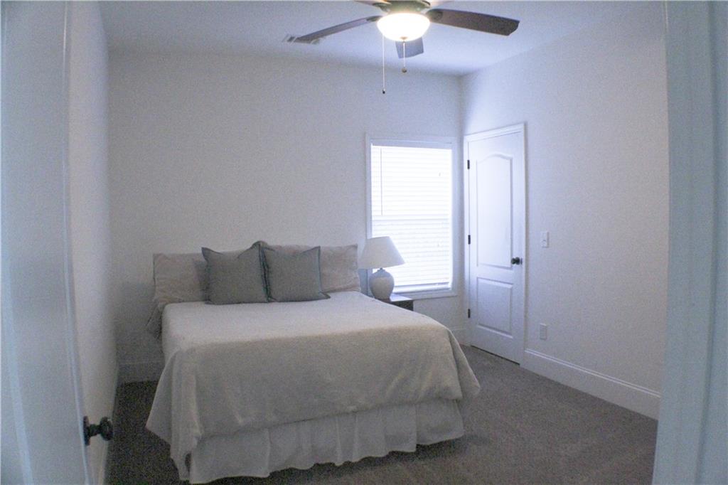 1175 Diamond Hill Colbert Road Colbert, GA 30628 - Photo 26 of 27 a bedroom with a bed and a chandelier