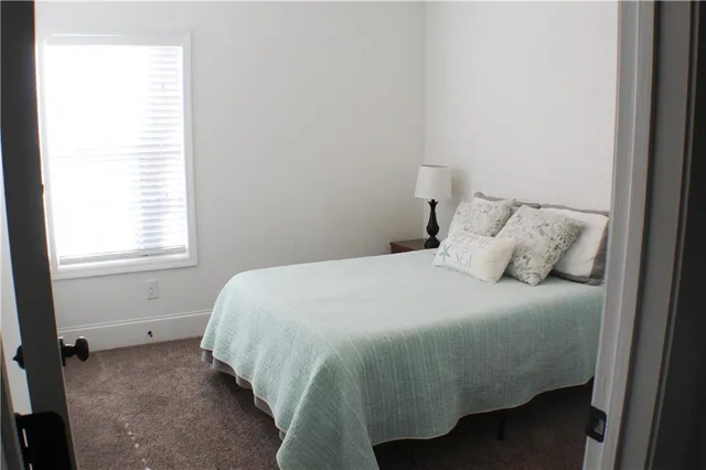 a bedroom with a bed and window