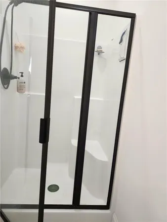 a bathroom with a granite countertop sink a large mirror and a bathtub