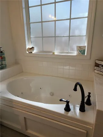 a close view of a sink a faucet and window in the bathroom