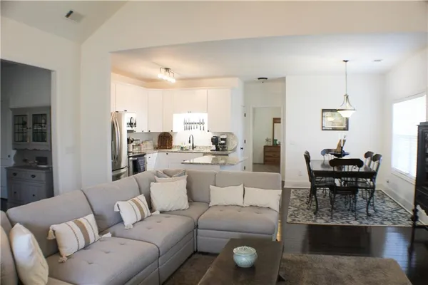 a living room with furniture and a piano
