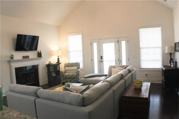 a living room with furniture a flat screen tv and a fireplace