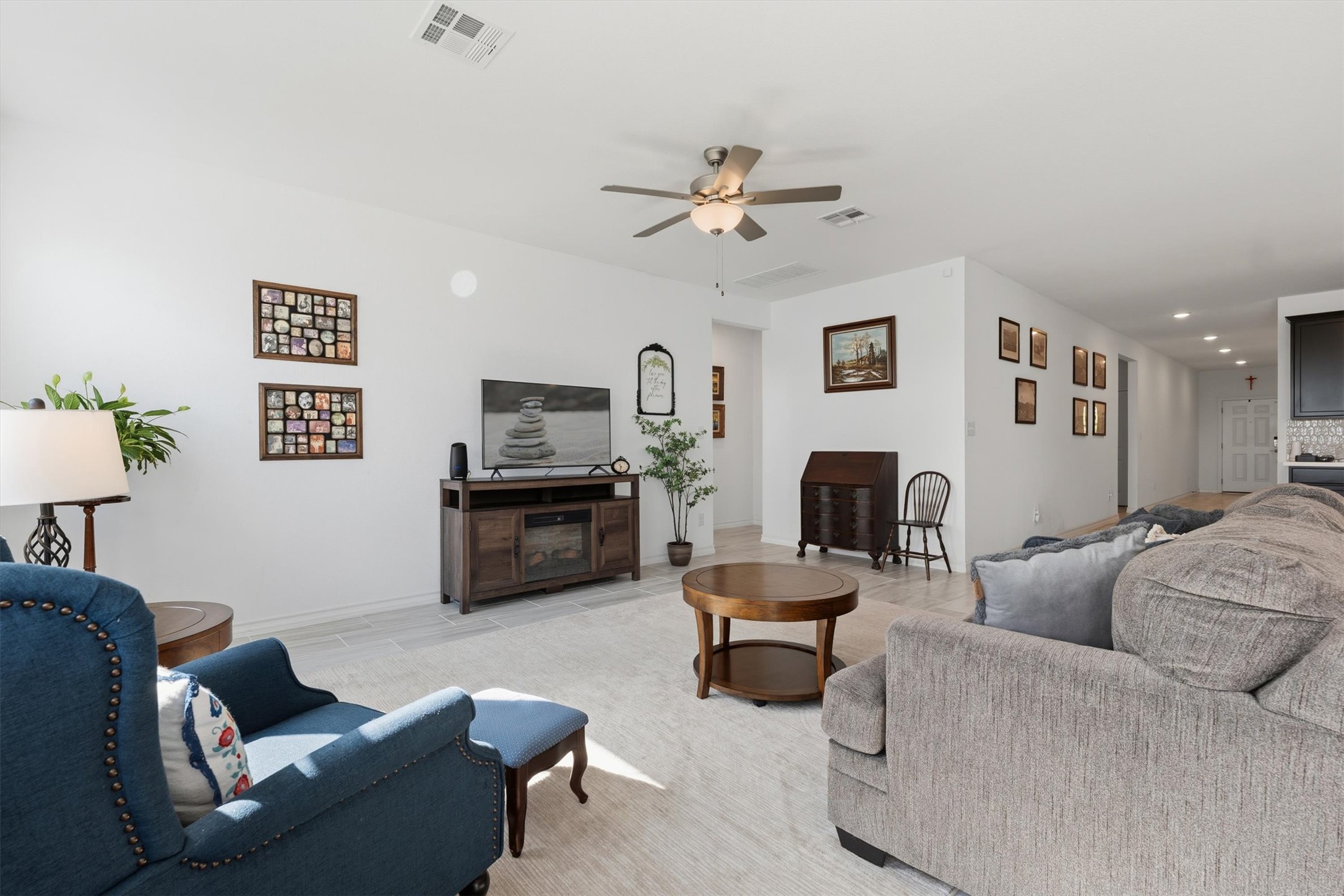 1000 Moose Road Hutto, TX 78634 - Photo 6 of 29 a living room with furniture a fireplace and a flat screen tv